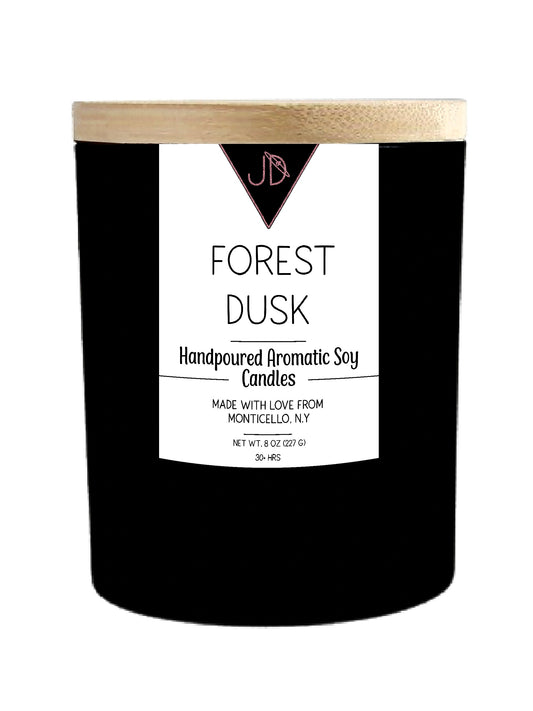 The forest at last light — cold air, dying embers, that stillness right before the stars come out. Forest Dusk opens with crisp fir needles and smoked wood, warming into clove, peppercorn, and cedarwood, with a soft campfire-sweetness of burnt marshmallow woven through. It settles into a deep, grounding base of patchouli, sandalwood, amber, and musk.

This one is pure comfort — the scent of coming inside after a long walk, wrapping up in a blanket, and finally exhaling.

Hand-poured in small batches in Mont
